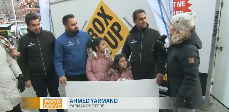 Ahmed Yarmand hands over a $5,640 cheque to the Ottawa Food Bank